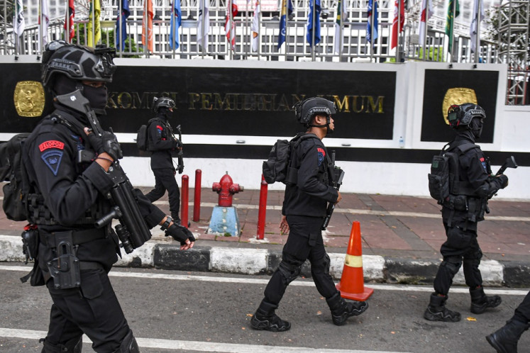 Personnel of the National Police's Mobile Brigade (Brimob) patrol in front of the General Elections Commission (KPU) headquarters in Central Jakarta in early November 2023.