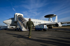 A crew member checks a NATO Airborne Warning and Control System (AWACS) aircraft, which participates in the German-led multinational exercise Air Defender 23, at the military base of Geilenkirchen, western Germany, on June 20, 2023. NATO plans to replace the ageing feelt of AWACS aircraft with Boeing E-7A Wedgetail