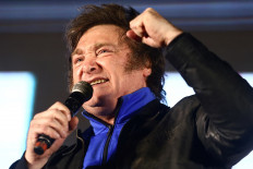 Then Argentine presidential candidate Javier Milei raises a fist during the closing event of his electoral campaign ahead of the November 19 runoff election, in Cordoba, Argentina, November 16, 2023.