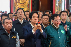 Taiwan's ruling Democratic Progressive Party (DPP) presidential candidate and current Vice President Lai Ching-te (center) offers prayers at the Zhenfu Taoist temple while campaigning in Taoyuan on November 16, 2023.