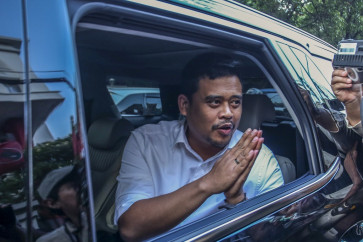 North Sumatra's Medan mayor Bobby Nasution greets the press from inside his car on Nov. 6, 2023, following a meeting at the Indonesian Democratic Party of Struggle (PDI-P) headquarters in Jakarta.