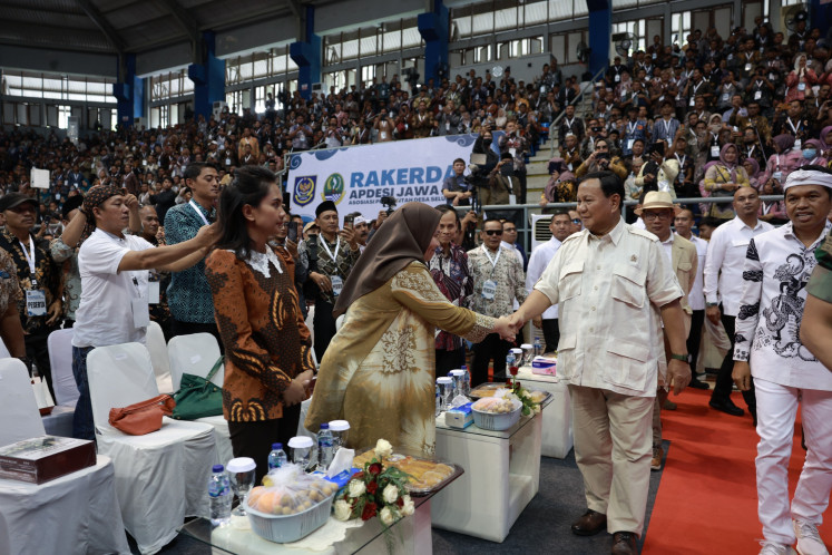 Defense Minister Prabowo (second right) shakes hands with a participant of the 2023 working meeting of the  All-Indonesia Village Administration Association (Apdesi) at C-Tra Arena Sports Hall in Bandung, West Java, on Nov. 23, 2023. Prabowo expressed his optimism that Indonesia would be able to produce plant-based “green fuel“ to eliminate its reliance on imported crude oil.