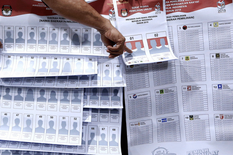 An officer from the General Elections Commission (KPU) introduces five different ballots in 2018, at the KPU building in Central Jakarta.    