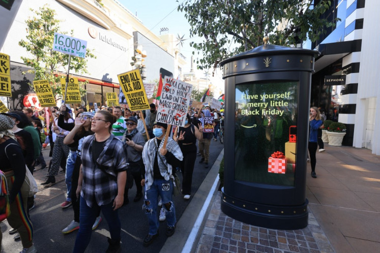 A large group of pro-Palestinian protesters march through The Grove shopping center on Black Friday, in Los Angeles, US, November 24, 2023. 