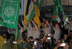 Palestinian prisoners (wearing grey jumpers) cheer after being released from the Israeli Ofer military facility in Baytunia near the city of Ramallah in the occupied West Bank in exchange for hostages freed by Hamas in Gaza, on Nov. 24, 2023. After 48 days of gunfire and bombardment that claimed thousands of lives, the first hostages to be released under a truce deal between Israel and Hamas were handed over on Nov. 24, both sides said, nearly seven weeks after they were seized.