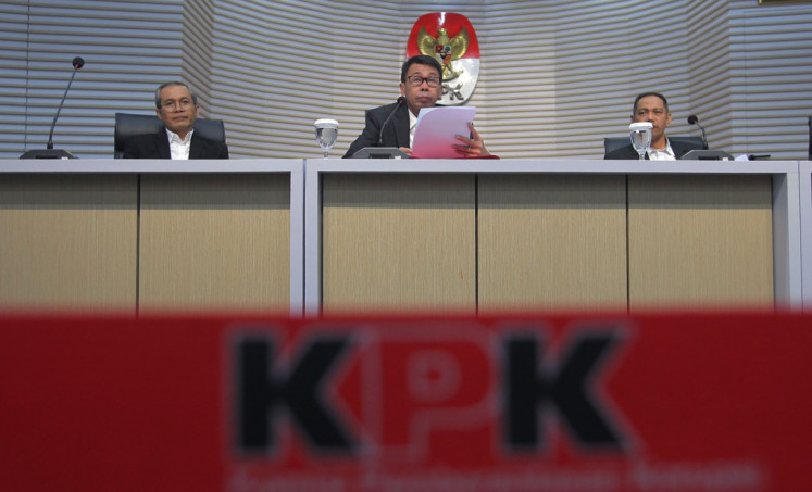 Interim Corruption Eradication Commission (KPK) chair Nawawi Pomolango (center), accompanied by commissioners Nurul Gufron (right) and Alexander Marwata (left), speaks during a press briefing at the antigraft body headquarters in Jakarta on Nov. 27, 2023. The new KPK chief aims to restore public confidence in the institution after its former chairman was charged with extortion of a former minister.