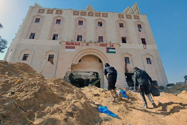People walk toward the Indonesia Hospital at the edge of the Jabalia refugee camp in the northern Gaza Strip, after Israeli troops reportedly raided the medical facility, on Nov. 24, 2023.  The hospital has since been destroyed since it was accused of sitting atop of Hamas tunnels. 