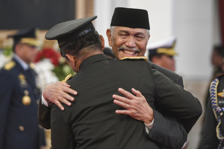 Coordinating Maritime Affairs and Investment Minister Luhut Pandjaitan (right) embraces Gen. Maruli Simanjuntak, who is also his son-in-law, following the latter's inauguration as Army chief of staff at the State Palace in Jakarta on Nov. 29, 2023. Luhut made his first public appearance since his extended sick leave to congratulate his son-in-law for realizing his own dream to become Army chief of staff.