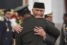 Coordinating Maritime Affairs and Investment Minister Luhut Pandjaitan (right) embraces Gen. Maruli Simanjuntak, who is also his son-in-law, following the latter's inauguration as Army chief of staff at the State Palace in Jakarta on Nov. 29, 2023. Luhut made his first public appearance since his extended sick leave to congratulate his son-in-law for realizing his own dream to become Army chief of staff.