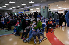 Children and their parents wait in an outpatient area of a children’s hospital in Beijing on Nov. 23, 2023. China has reported an increase this year in “influenza-like illness”.