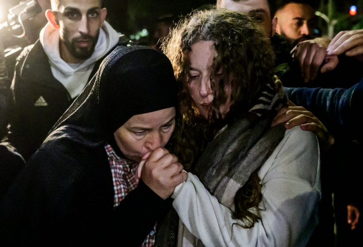 Newly released activist Ahed Tamimi (right) is greeted by relatives during a welcome ceremony following the release of Palestinian prisoners from Israeli jails in exchange for Israeli hostages held in Gaza by Hamas since the Oct. 7 attacks, in Ramallah in the occupied West Bank early on Nov. 30, 2023.