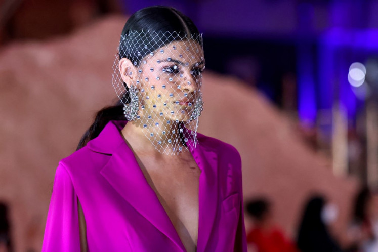 A model presents a creation by Saudi designer Honayda Serafi during the Riyadh Fashion Week in King Abdullah Financial District KAFD in the capital Riyadh on Oct. 22, 2023. On a runway in Riyadh's financial district, before a mixed-gender crowd of Instagram influencers and diplomats, models donned creations by both veteran and up-and-coming Saudi designers, a world away from most prior fashion shows in the Gulf kingdom.