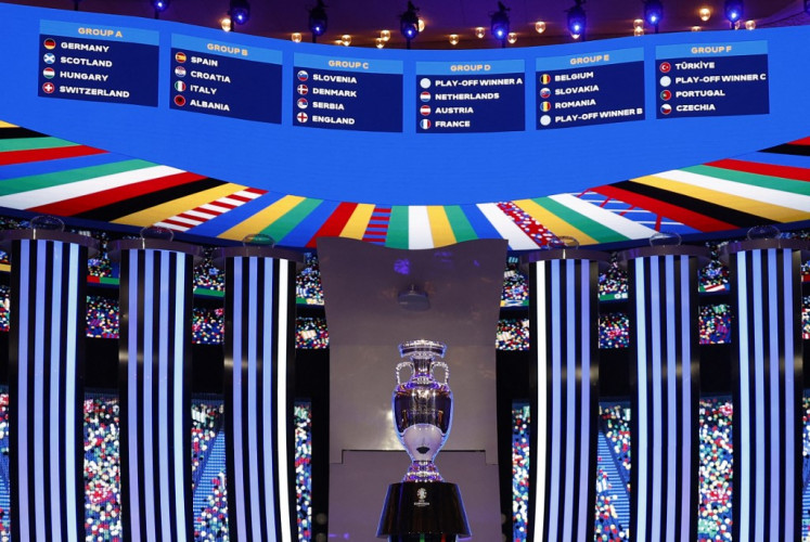 A general view shows the trophy in front of the drawn groups after the final draw for the UEFA Euro 2024 European Championship football competition in Hamburg, northern Germany on Dec. 2, 2023.