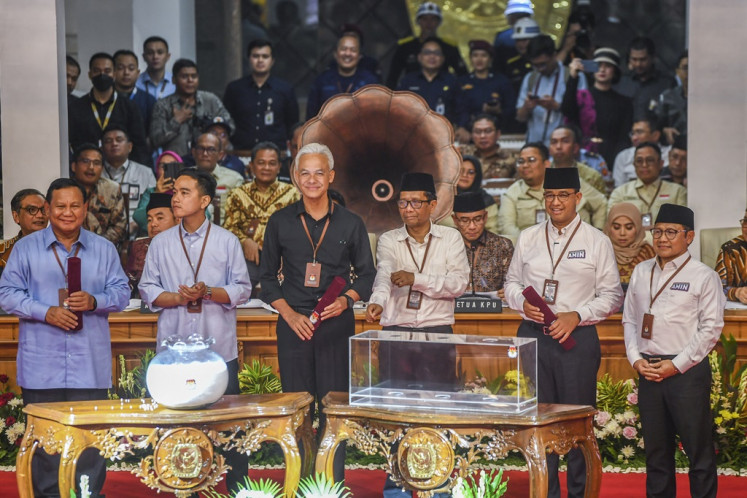 Presidential and vice presidential candidates (from left) Prabowo Subianto and running mate Gibran Rakabuming Raka, Ganjar Pranowo and running mate Mahfud MD and Anies Baswedan and running mate Muhaimin Iskandar pose for the press on Nov. 14, 2023, at the General Elections Commission (KPU) office in Jakarta.