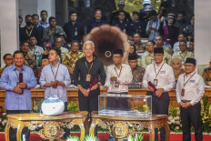 Presidential and vice presidential candidates (from left) Prabowo Subianto and running mate Gibran Rakabuming Raka, Ganjar Pranowo and running mate Mahfud MD and Anies Baswedan and running mate Muhaimin Iskandar pose for the media on Nov. 14, 2023, at the General Elections Commission (KPU) office in Jakarta.