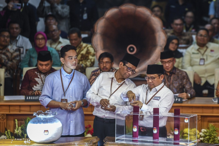 Three 2024 vice presidential candidates (from left) Gibran Rakabuming Raka, Mahfud MD and Muhaimin Iskandar draw their unique numbers on the ballot at the General Elections Commission (KPU) headquarters in Jakarta on Nov. 14, 2023. 