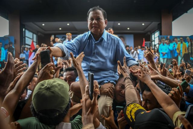 Campaign trail: Presidential candidate Prabowo Subianto (center) shakes hands with members of the crowd on Dec. 2, 2023 during a meeting with religious and community figures at the Primajasa bus terminal in Tasikmalaya, West Java. 