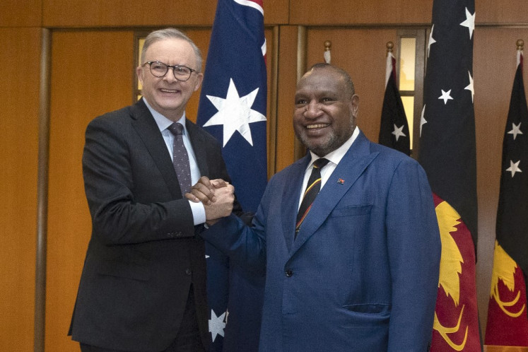 Papua New Guinea’s Prime Minister James Marape (right) shakes hands with Australia’s Prime Minister Anthony Albanese in Parliament House in Canberra on December 7, 2023. 