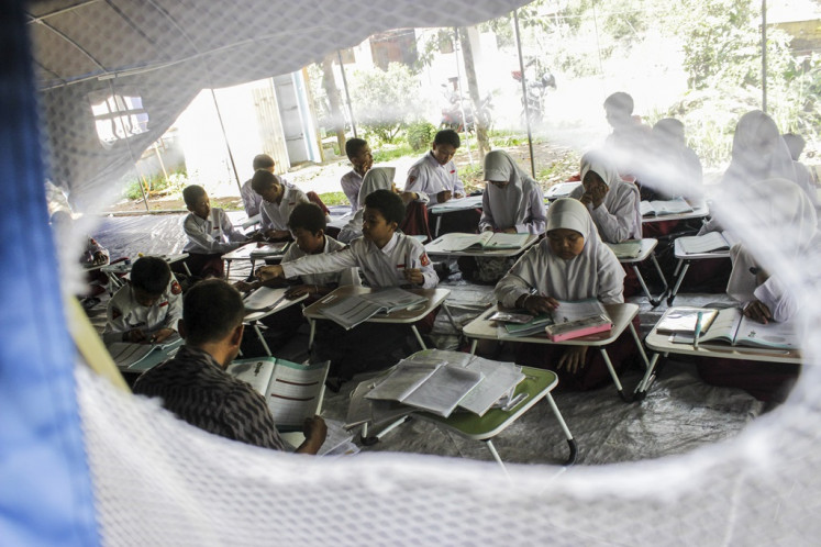 Students study in a makeshift school in Cianjur regency, West Java, on Nov. 21, 2023 after a 5.6-magnitude earthquake rocked the regency, killing nearly 300 people and damaging more than 20,000 buildings.