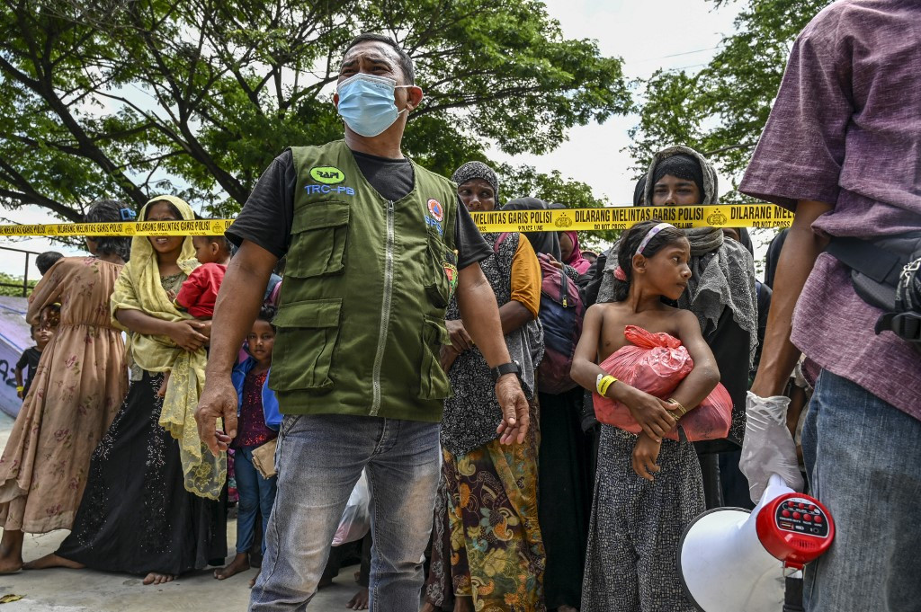 Newly arrived Rohingya refugees wait to board trucks to move to a temporary shelter after villagers rejected their relocated camp in Banda Aceh, Aceh, on Dec. 11, 2023. Some of the more than 300 Rohingya refugees who arrived on the western coasts of Indonesia on Dec. 10 were transferred to a temporary shelter during the visit of a United Nations representative.