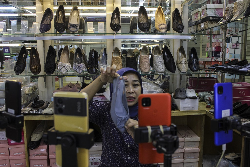 A seller promotes products on a live stream on Dec. 11, 2023, at Tanah Abang Market in Central Jakarta.