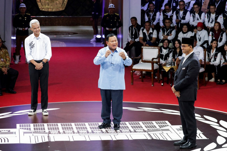 Ganjar Pranowo, presidential candidate of the Indonesian Democratic Party of Struggle (PDI-P), Defense Minister and presidential candidate, Prabowo Subianto, and presidential candidate Anies Baswedan attend a televised debate at the General Elections Commission (KPU) headquarters in Jakarta on Dec. 12, 2023. 