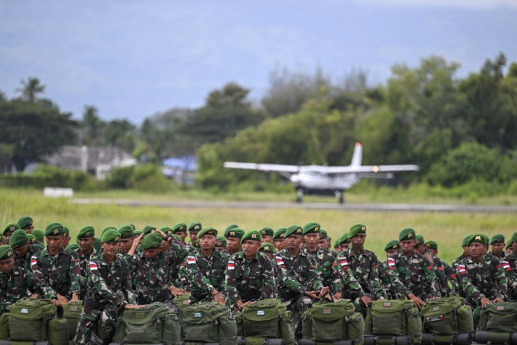 Indonesian soldiers take part in a ceremony before travelling to Papua for deployment in security operations at Sultan Iskandar Muda Air Force base in Blang Bintang, Aceh on Dec. 12, 2023.