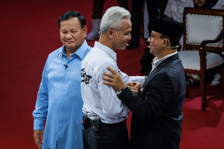 Three presidential candidates, Anies Baswedan (right), Ganjar Pranowo (center) and Prabowo Subianto greet each other after the first presidential election debate at the General Elections Commission (KPU) office in Jakarta on December 12, 2023.
