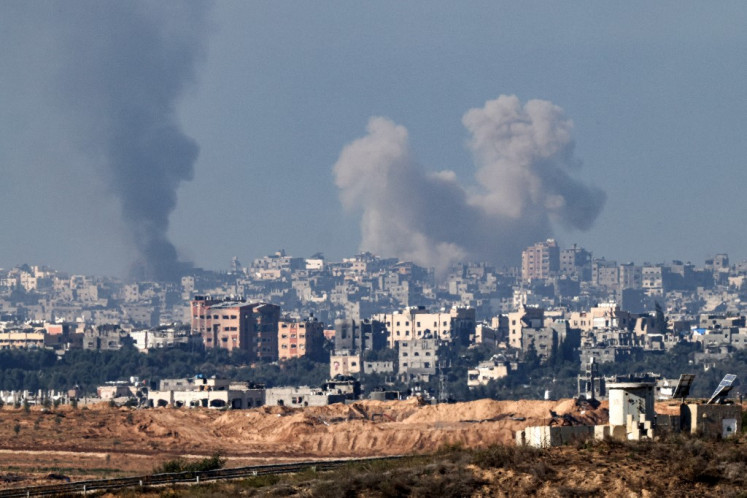 Smoke billows over the northern Gaza Strip during Israeli bombardment from southern Israel on Dec. 15, 2023, as the country's military continues to flatten most of the territory in its war against Palestine. 