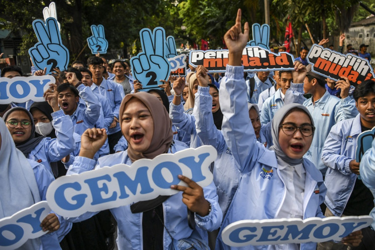 Young supporters of the Prabowo Subianto-Gibran Rakabuming Raka candidate pair take to the street in Menteng, Jakarta, on Dec. 14, 2023, during the launching of a digital platform that aims to woo young voters to vote in the 2024 elections.