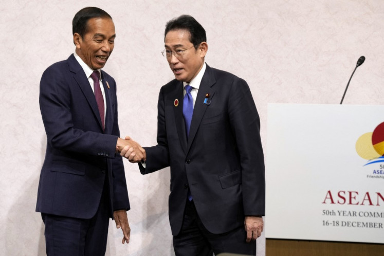 Indonesian President Joko &ldquo;Jokowi&ldquo; Widodo (left) and Japanese Prime Minister Fumio Kishida shake hands at their Joint Chairpersons' Press Announcement after the ASEAN-Japan Commemorative Summit Meeting in Tokyo on Dec. 17, 2023.