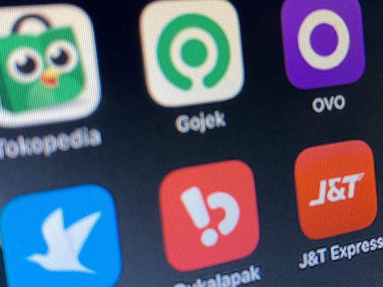 The app icons of six Indonesian unicorns (clockwise from top left), e-commerce platform Tokopedia, on-demand transportation company Gojek, digital wallet OVO, parcel and courier service company J&T Express, e-commerce platform Bukalapak and online travel agency Traveloka, are displayed on a smartphone menu, in this illustration created on Aug. 3, 2021.