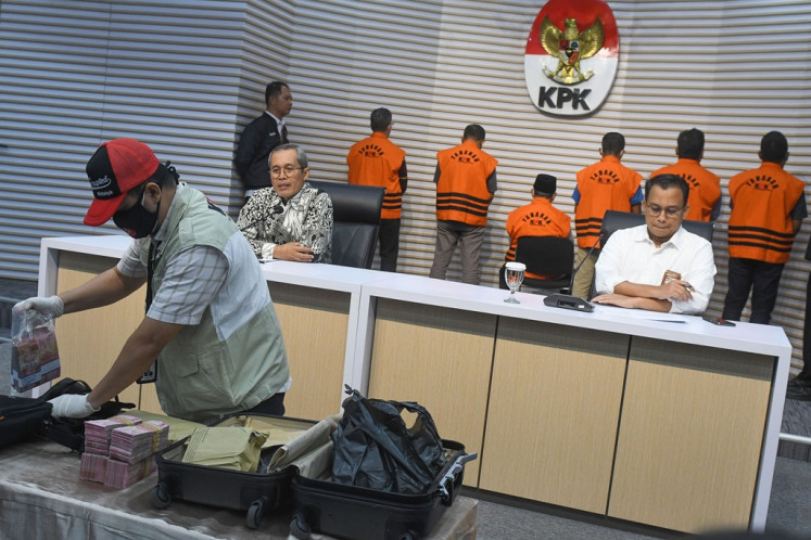 Corruption Eradication Commission (KPK) investigators show money in cash as evidence used to name North Maluku Governor Abdul Gani Kasuba as a corruption suspect during a press briefing at the antigraft body's headquarters in Jakarta on Dec. 20, 2023. The antigraft body names him a corruption suspect in a case pertaining to an infrastructure project after arresting him in an operation on Dec. 19.