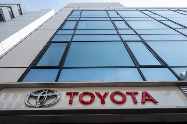 Signage is pictured outside a car dealership for Japanese automaker Toyota in Tokyo on May 10, 2023. 