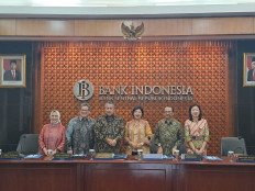 Members of Bank Indonesia's board of governors pose for a photo at a press conference in the central bank's Jakarta headquarters on Dec. 12, 2023.