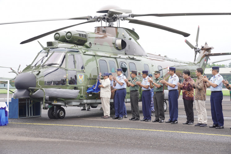 Defense Minister Prabowo Subianto unveils the eighth Squadron logo on the fuselage of an H225M heavy helicopter at the Atang Sendjaja Air Force Base in Bogor, West Java, on Dec. 1, 2023. State-owned aircraft maker PT Dirgantara Indonesia (PTDI) handed over eight H225M helicopters to the 8th Squadron. 