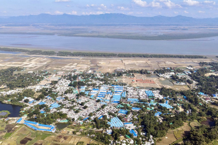 This aerial photograph taken on Nov. 24, 2023 shows a view of the Nayapara Rohingya refugee camp, along the Naf river at Teknaf in Bangladesh's southeastern district of Cox's Bazar. Rohingya refugees had hoped for a safe space at camps in Bangladesh after fleeing brutal violence in Myanmar but many of the persecuted ethnic minority are risking another dangerous sea crossing to escape hunger, kidnapping and gang violence.