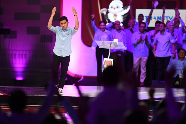 Vice presidential candidate Gibran Rakabuming Raka raises his hands during the second 2024 election debate at the Jakarta Convention Center on Dec. 22, 2023.