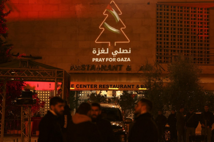 A message in support of Gaza is displayed on a building next to the square of the Church of the Nativity in the biblical city of Bethlehem in the occupied West Bank on Dec. 24, 2023, ahead of midnight mass.