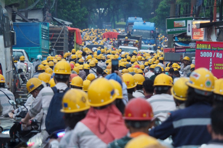 Employees of nickel company PT Indonesia Morowali Industrial Park (IMIP) head home after work in Konawe, Central Sulawesi, on April 14, 2023.