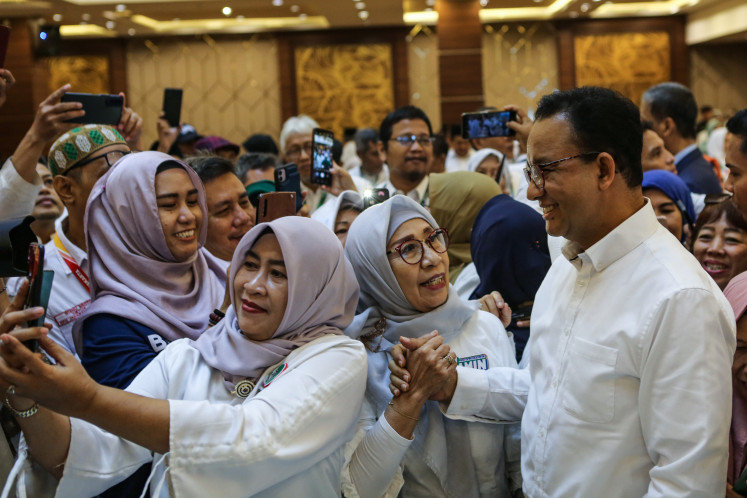 Presidential candidate Anies Baswedan (right) greets the women of the Extended Family of the Assembly of Muslim Students’ (KB HMI) on Dec. 27, 2023, during an event to show support for Anies in Jakarta.