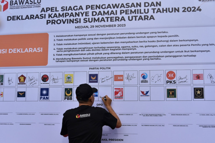 A political party representative signs on Nov. 29, 2023 the Declaration on the 2024 Peaceful Election Campaign during a ceremony at Maimun Palace in Medan, North Sumatra.