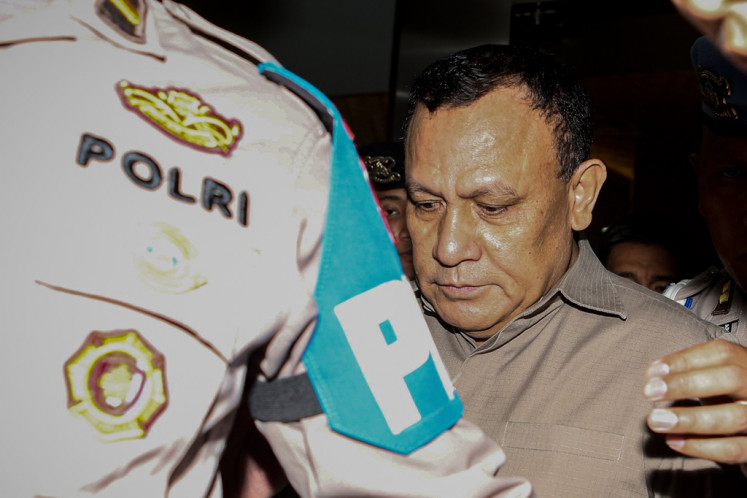 Suspended Corruption Eradication Commission (KPK) chairman Firli Bahuri leaves the National Police's Criminal Investigation Agency (Bareskrim) headquarters  in Jakarta on Dec. 27, 2023, following an interrogation.