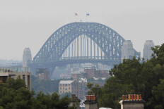 A view of the Sydney Harbour Bridge shrouded in smog from nearby bushfires in Sydney, Australia, December 19, 2023. 