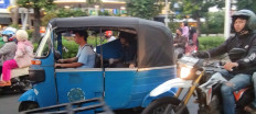 A motorized tricycle taxi running on compressed natural gas (CNG) conveys a passenger on Jl. Kyai Haji Moh. Syafi'i Hadzami in South Jakarta on Dec. 20, 2023.
