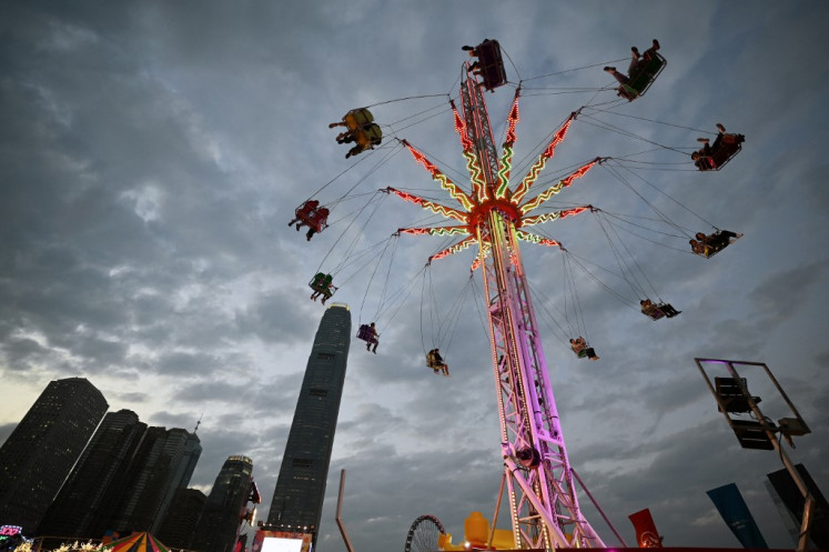 People enjoy an amusement ride at a holiday carnival in Hong Kong, China, on Dec. 29, 2023. 