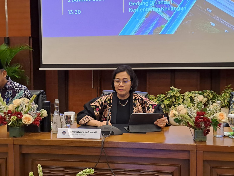 Finance Minister Sri Mulyani Indrawati prepares devices she is about to use for the state budget presentation before the press in the Ministry's headquarter in Jakarta, on Jan. 2, 2024.