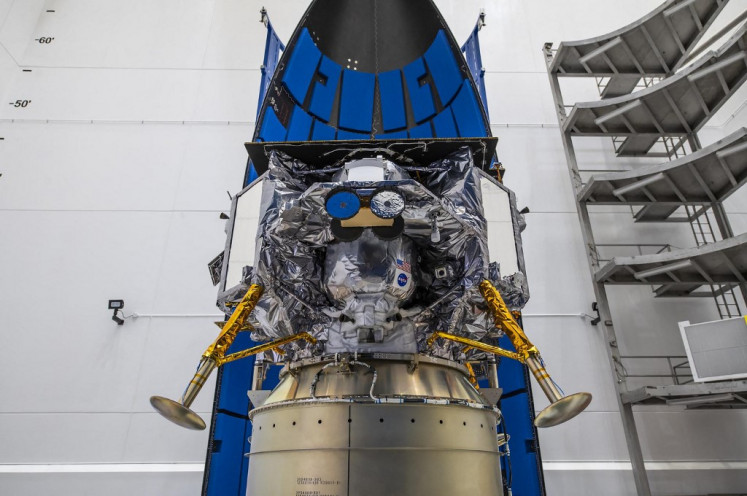 This image released by NASA shows Astrobotic's Peregrine lunar lander being encapsulated in the payload fairing, or nose cone, of United Launch Alliance's Vulcan rocket on Nov. 21, 2023, at Astrotech Space Operations Facility near the agency's Kennedy Space Center in Florida.