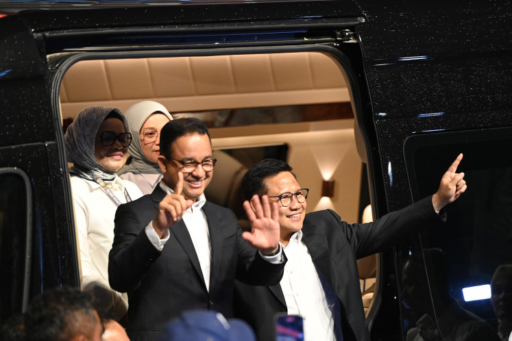 Presidential candidate Anies Baswedan and running mate Muhaimin Iskandar greet the crowd on Jan. 7, 2024, upon their arrival at Istora Senayan in Jakarta, ahead of the third televised debate on defense and foreign policy.