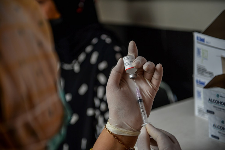 A health worker prepares COVID-19 vaccine for patients at Arcamanik community health center (puskesmas) on Jan. 4, 2024, in Bandung, West Java. 